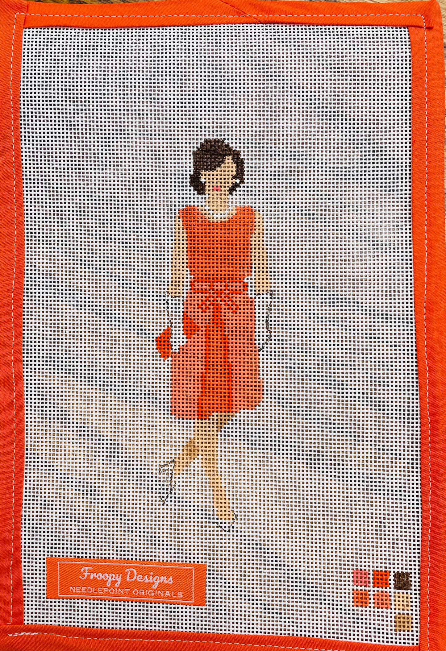 “JACKIE IN ORANGE”, 5.5” x 2.5” on 18 mesh